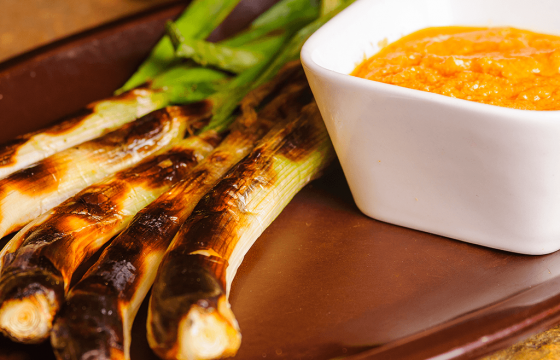 Grilled mexican green onions with Romesco sauce