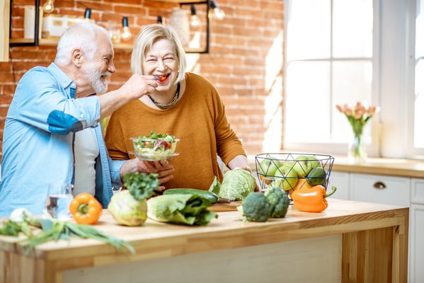 Senior couple with healthy food at home